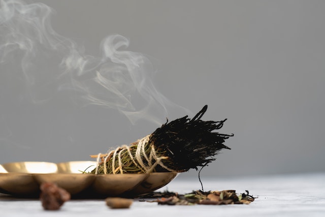 smudging, spiritual cleansing, to remove evil, negative energy and darl cloud